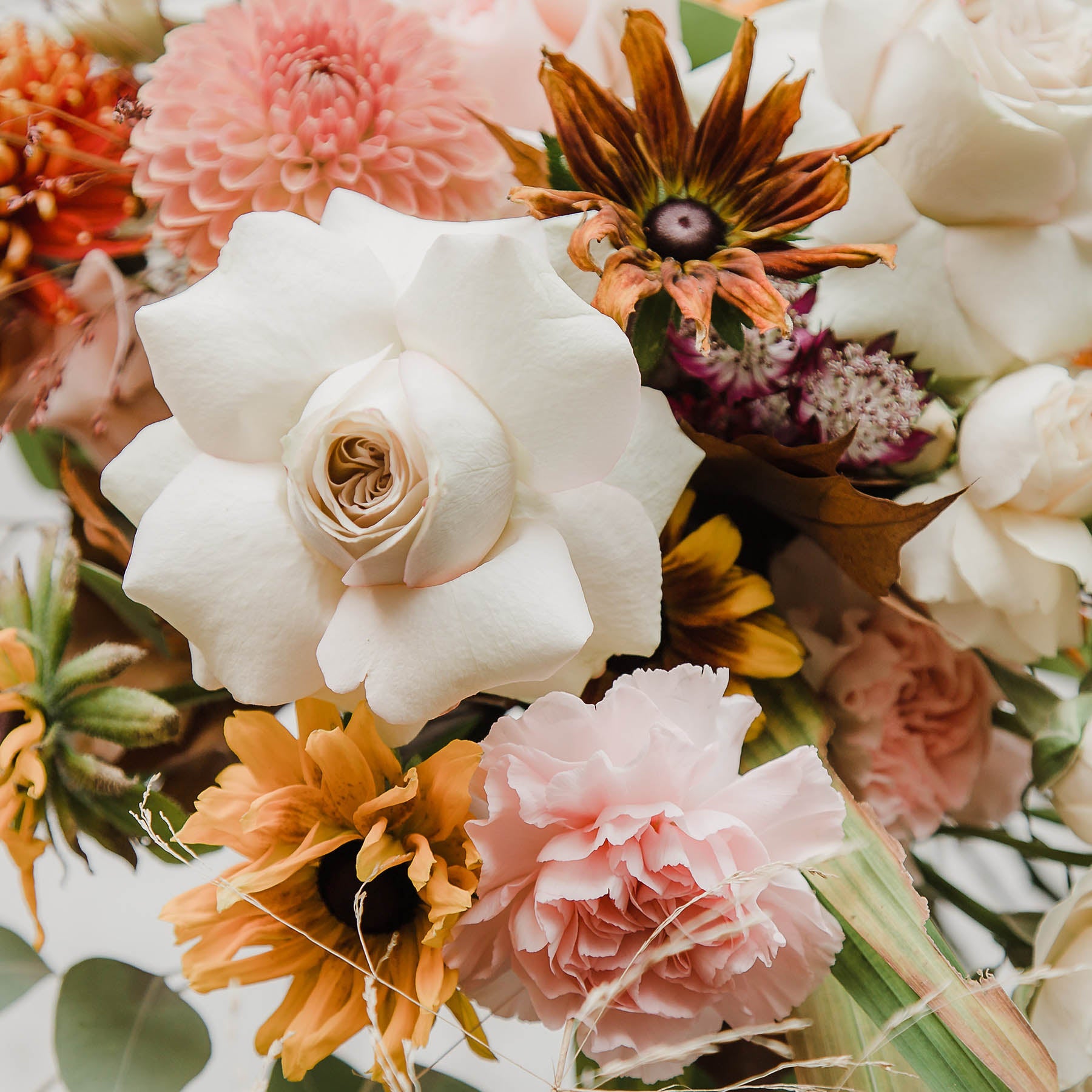 This beautiful seasonal bouquet with a soft autumn palette, dahlias, sunflowers, rudbeckias and large roses from Edinburgh Florist Aspen Florals 